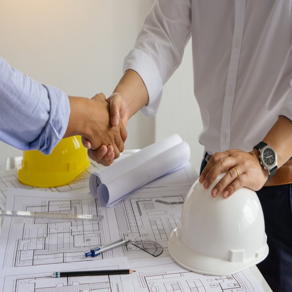 Successful deal.Engineer and contractor shaking hands success of the project work together.