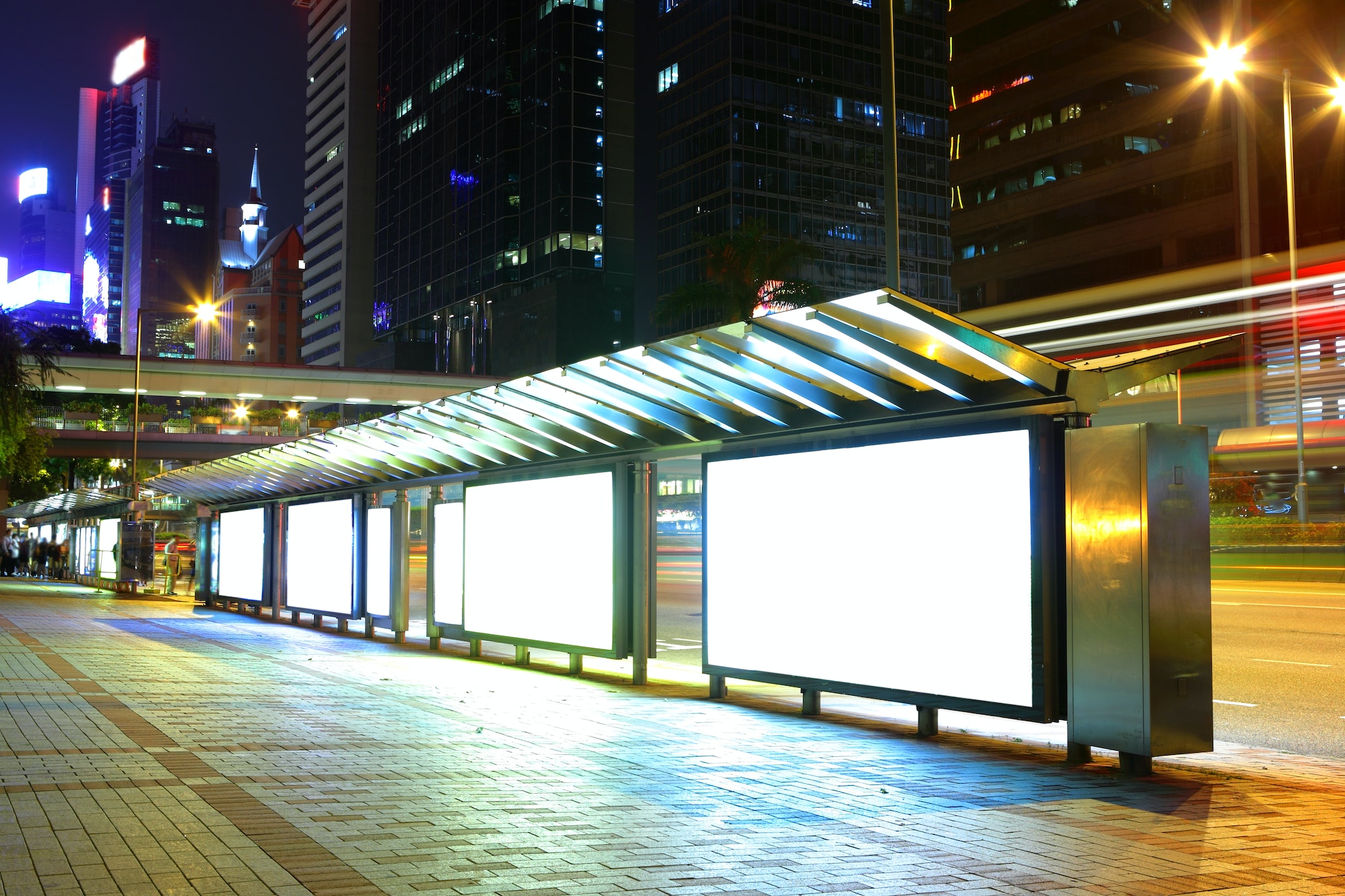 Blank billboard on bus stop at night